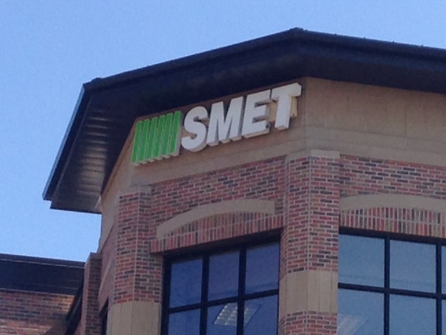 Smet green logo on building